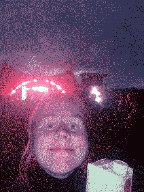 A happy Ida in front of Orange stage with cheap rosé wine